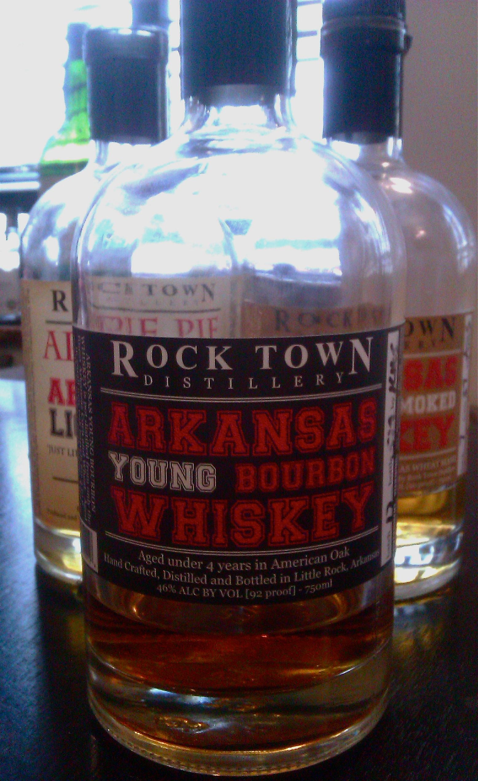 Bottle of Rock Town Arkansas Young Bourbon Whisky in front of two other bottles